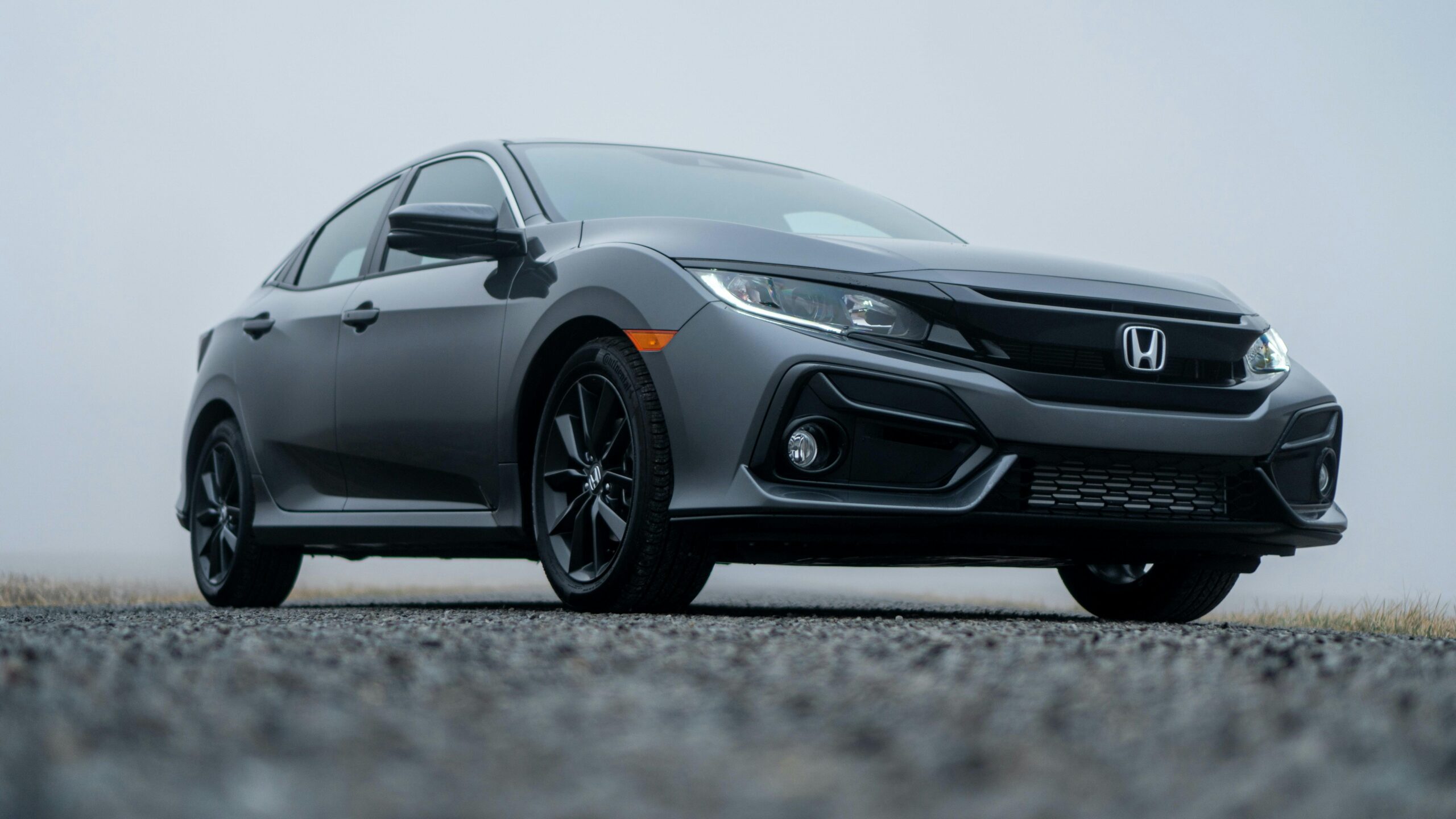 A sleek Honda Civic parked on a misty day in Fort Wayne, Indiana.